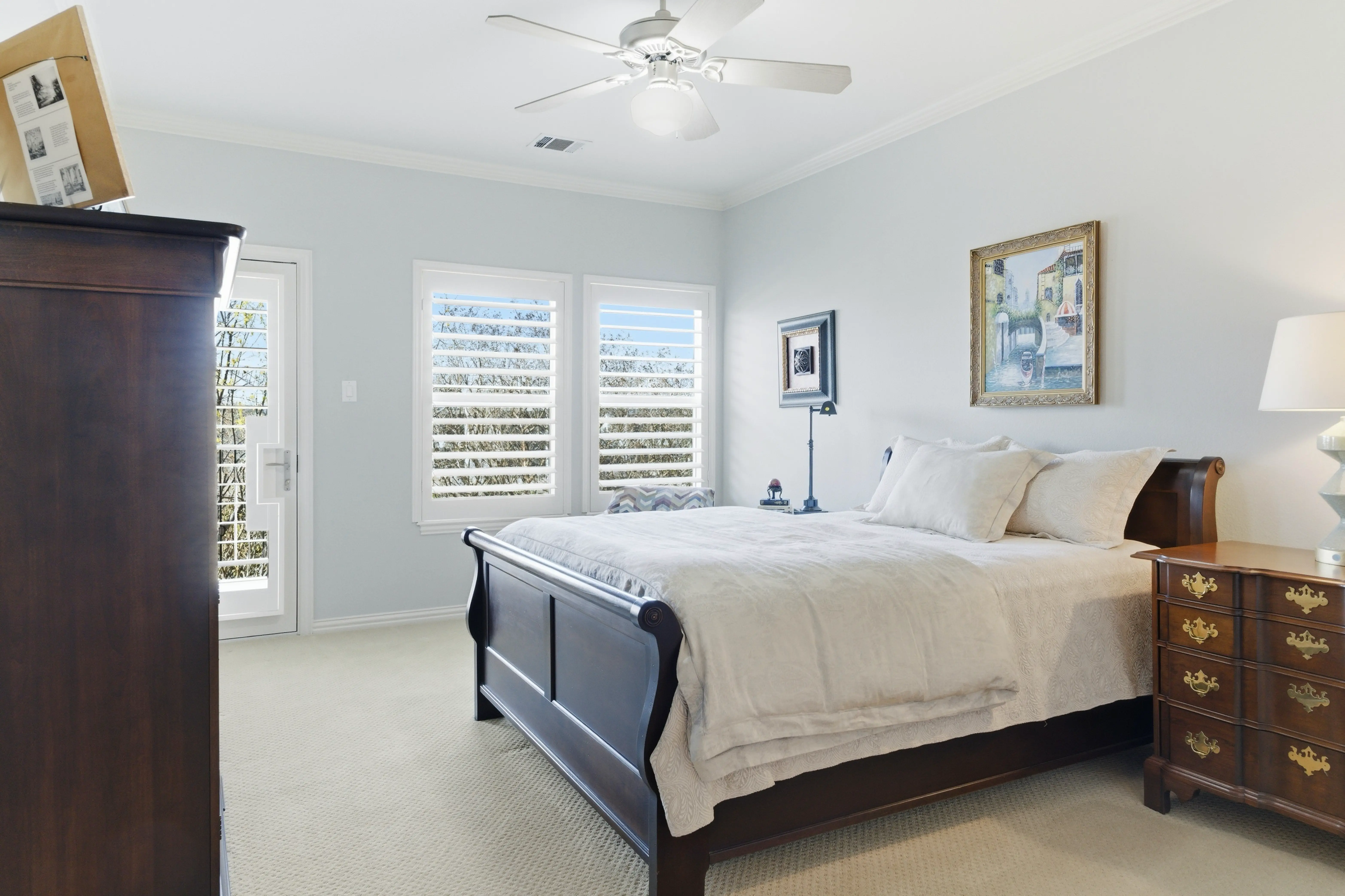 Guest bedroom with plantation shutters and natural light